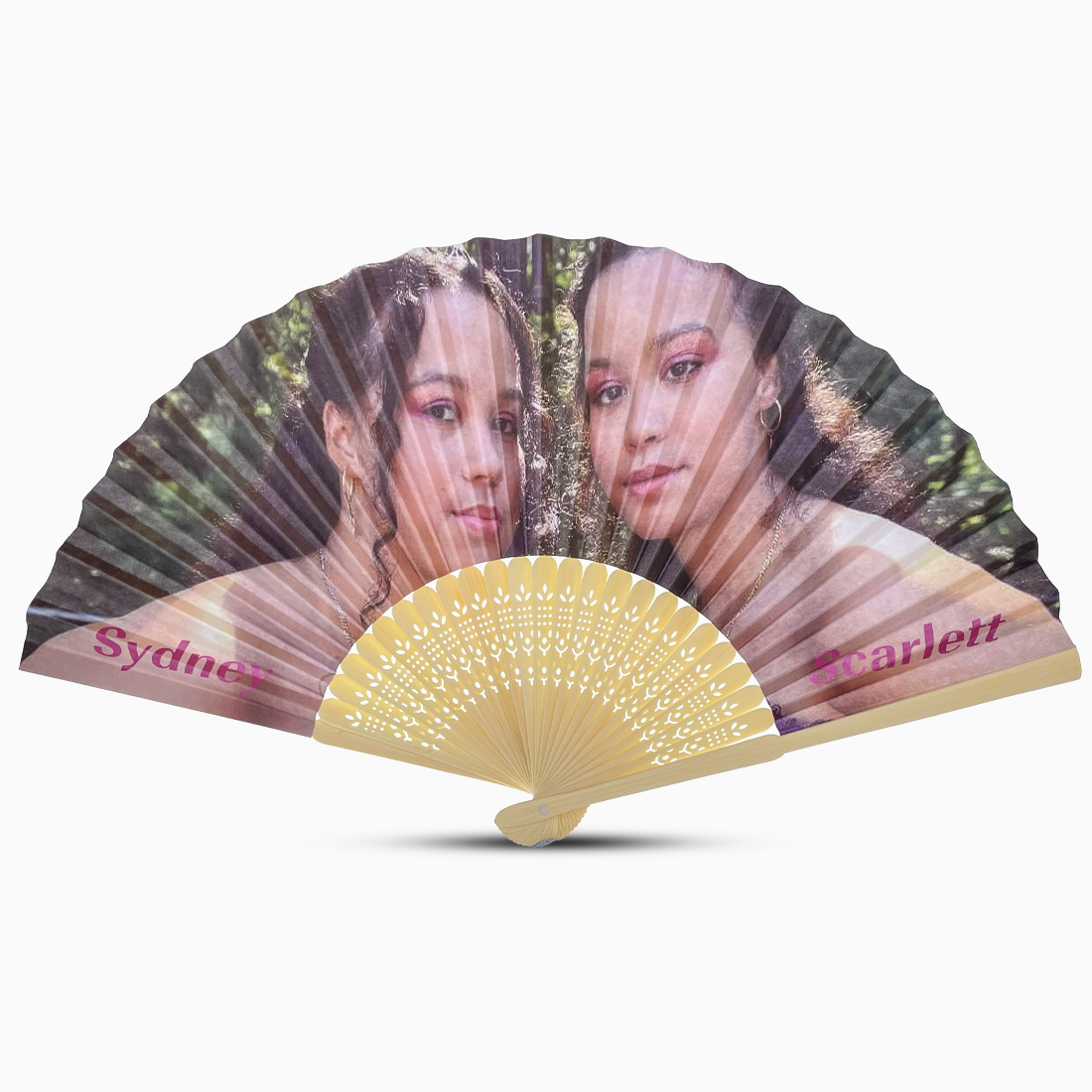 Hand fan featuring two photographs of girls, showcasing artistic design and personal touches.