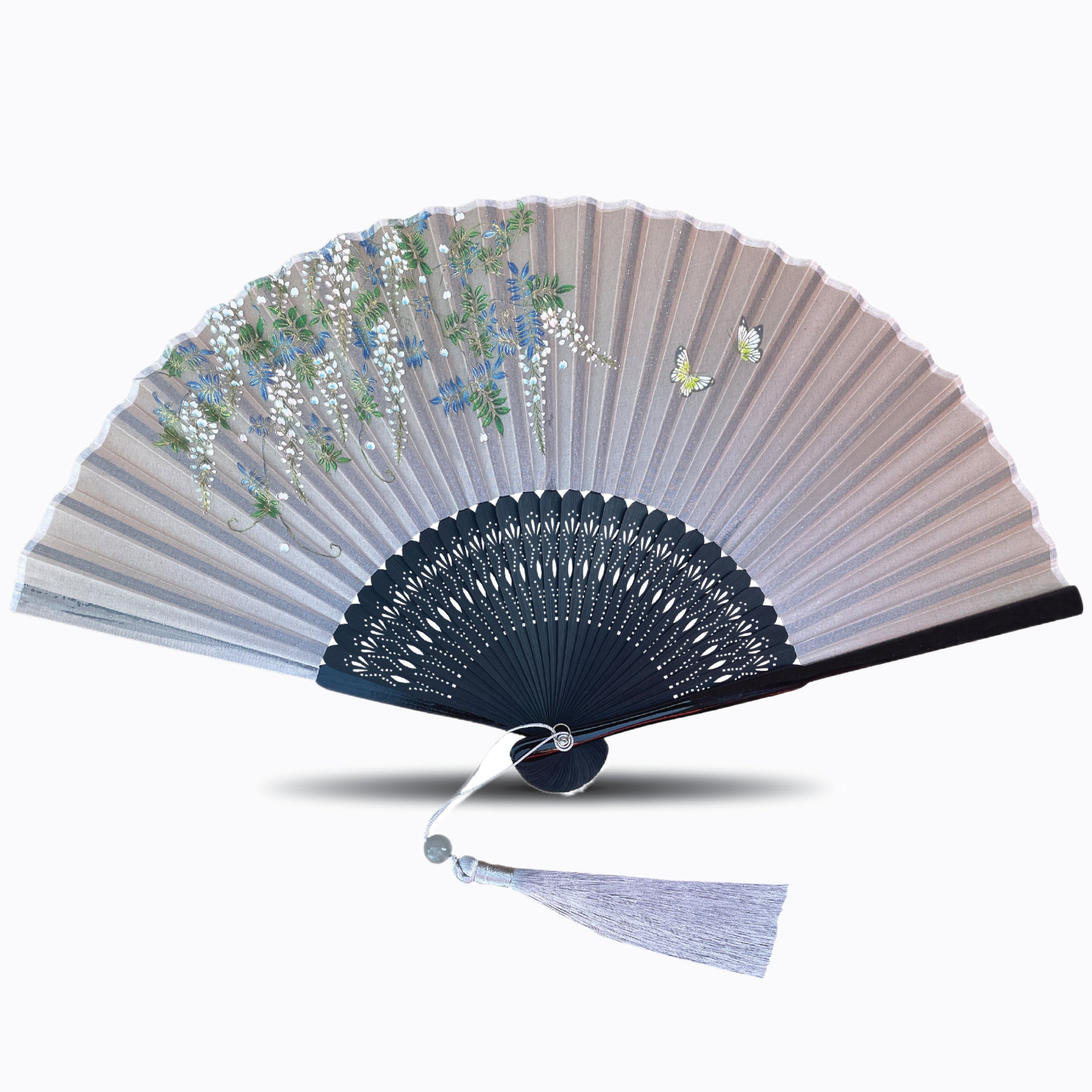 Silk folding hand fan featuring butterfly and cascading floral artwork, with finely cut dark bamboo ribs and a matching light tassel, shown on a white background