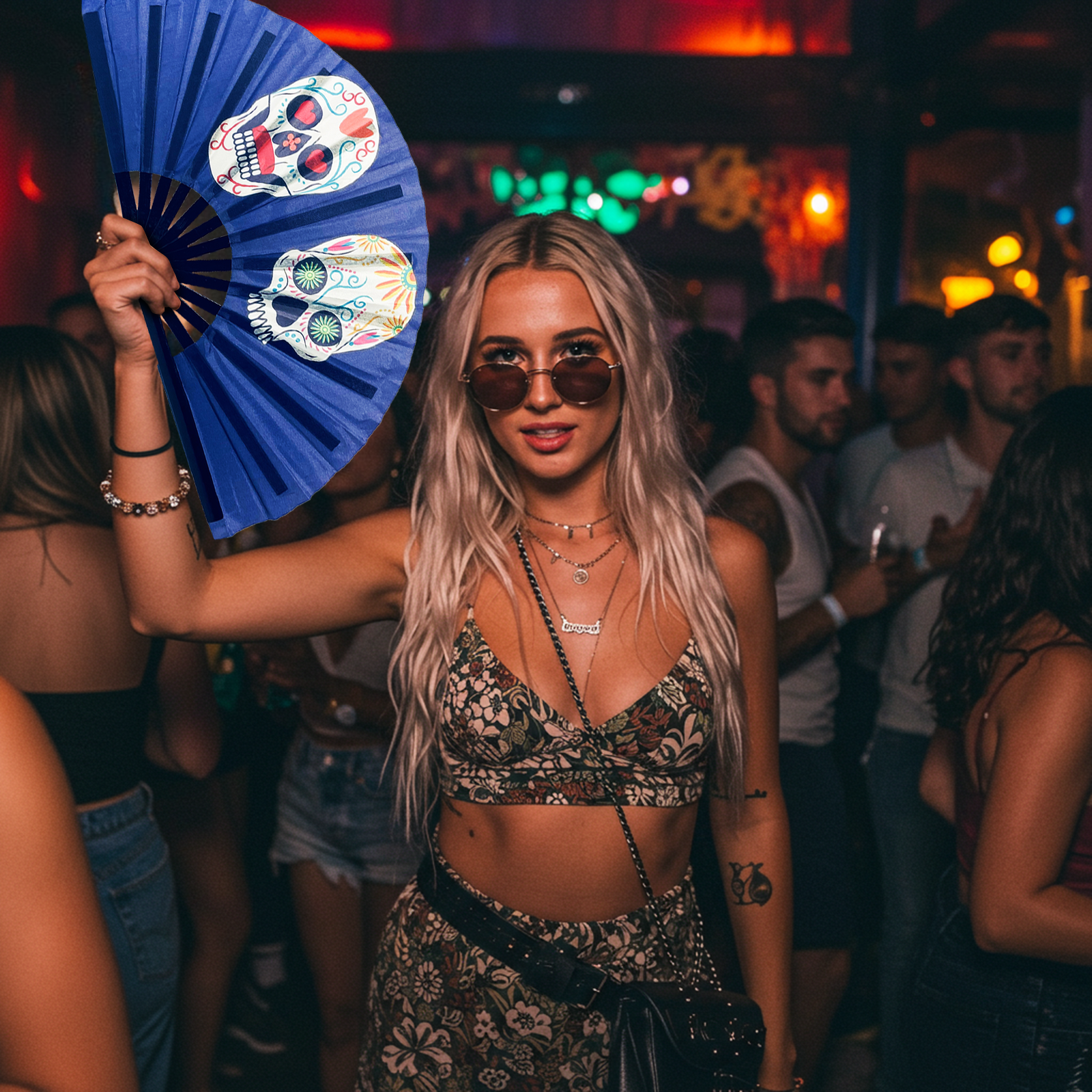 A woman in a bikini holds a rave fan, enjoying herself at a lively party atmosphere.