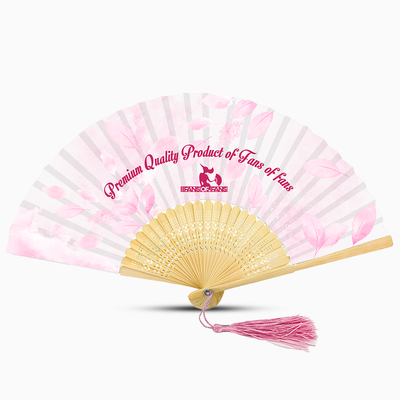 A pink hand fan featuring a leaf design and a pink tassel, elegantly displayed against a neutral background.