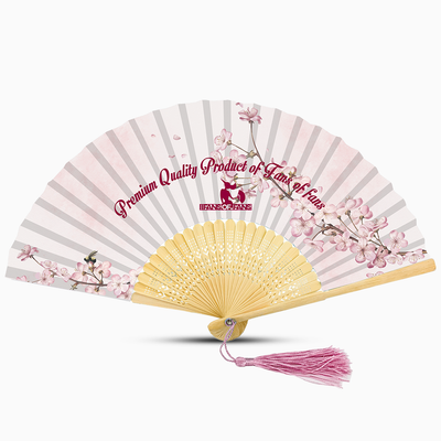 A pink hand fan featuring a floral design and a pink tassel, elegantly displayed against a neutral background.