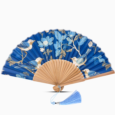 Blue hand fan with bird and floral design on a white background