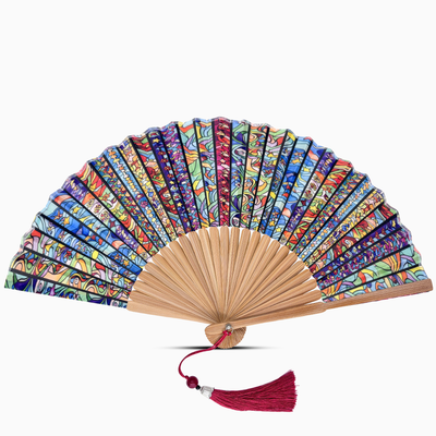 Colorful hand fan with wooden frame and red tassel on a white background