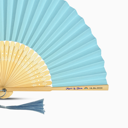 A Baby Blue solid color hand fan, featuring a personal message printed  on main rib.