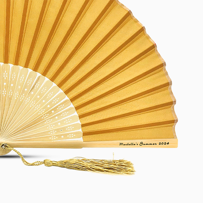 A Deep Gold solid color hand fan, featuring a personal message printed  on main rib.