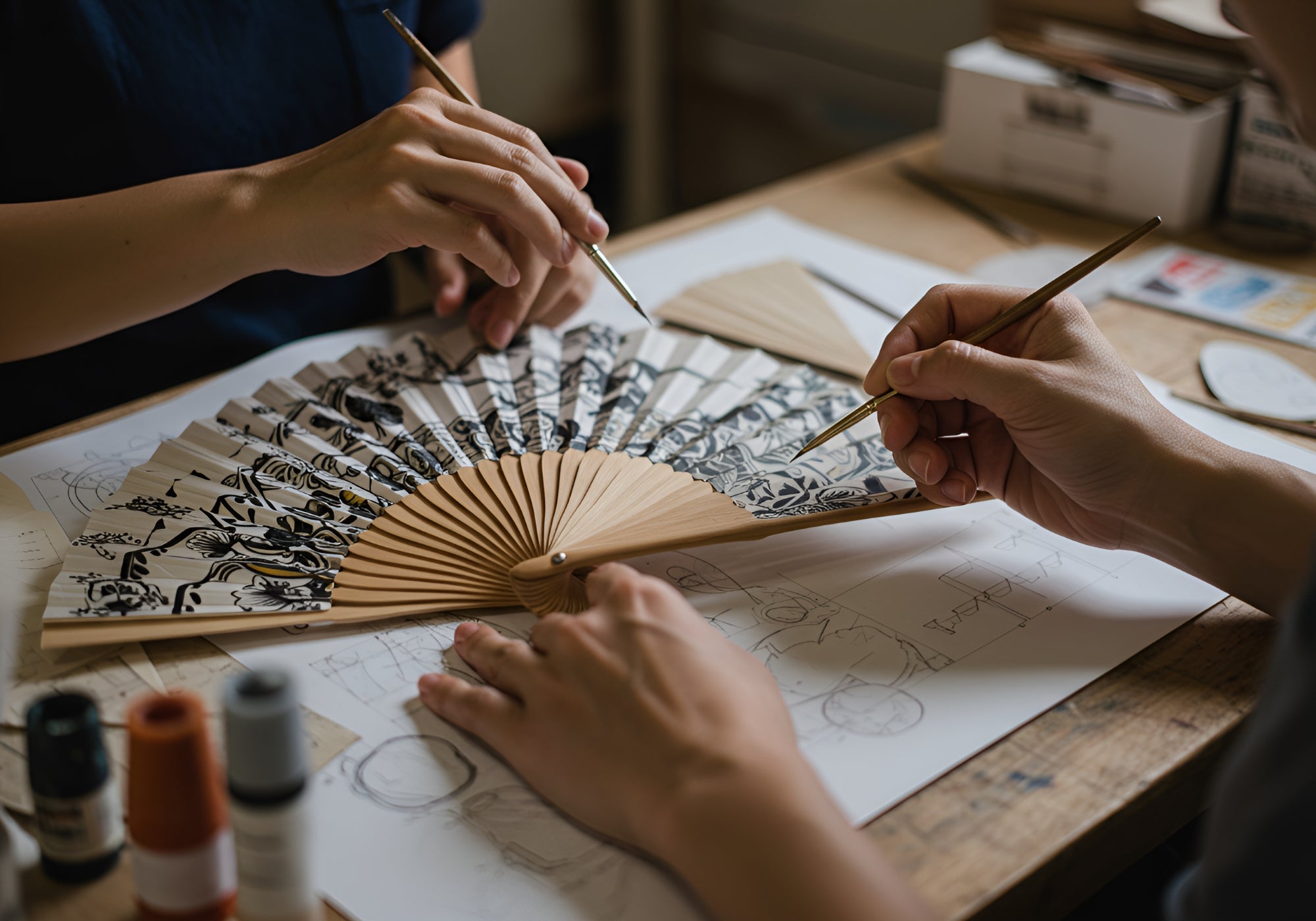 A person carefully brushes a hand fan, focusing on its intricate design and details.