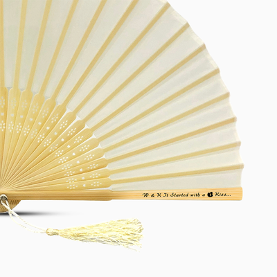 A Ivory Beige solid color hand fan, featuring a personal message printed  on main rib.