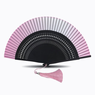 Pink folding hand fan with black hollow-carved bamboo ribs and matching pink tassel, displayed open on a white background