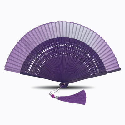 Purple hand fan with black hollow-carved bamboo ribs and matching purple tassel, displayed open on a white background