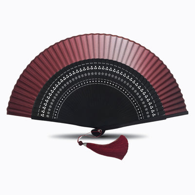 Maroon Color hand fan with black hollow-carved bamboo ribs and matching red tassel, displayed open on a white background