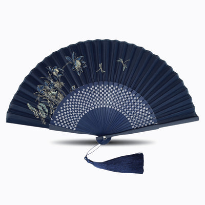 Navy blue silk folding hand fan with delicate floral and dragonfly artwork, featuring a geometric pattern, matching tassel, and elegant bamboo ribs