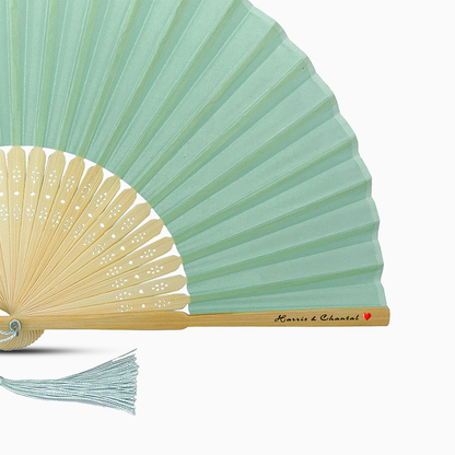 A Light Turquoise solid color hand fan, featuring a personal message printed  on main rib.
