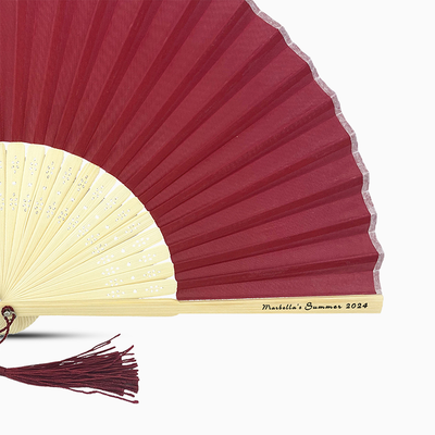 A Maroon Red solid color hand fan, featuring a personal message printed  on main rib.