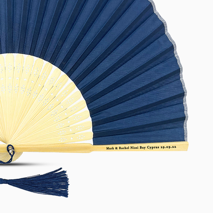A Navy Blue solid color hand fan, featuring a personal message printed  on main rib.