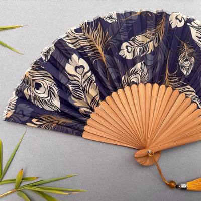 Handheld fan with peacock feather pattern on a gray background