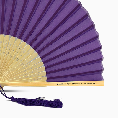 A Purple solid color hand fan, featuring a personal message printed  on main rib.