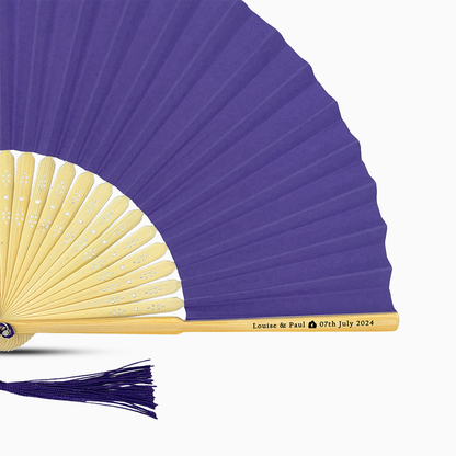 A Purple solid color hand fan, featuring a personal message printed  on main rib.