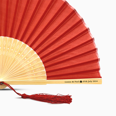 A Red solid color hand fan, featuring a personal message printed  on main rib.