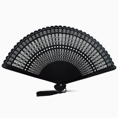  A black wooden hand fan with a round cut design and a decorative tassel attached.