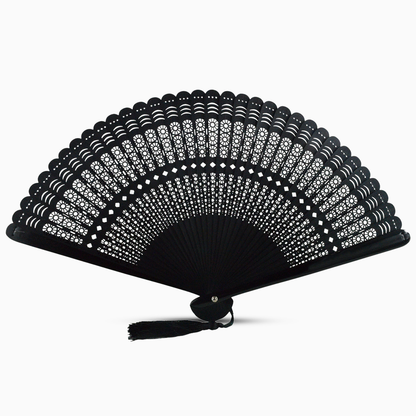  A black wooden hand fan with a round cut design and a decorative tassel attached.