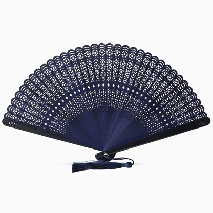 A navy blue wooden hand fan with a round cut design and a decorative tassel attached.