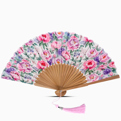 Floral-patterned hand fan with pink tassel on a white background
