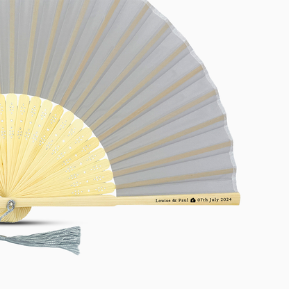 A Silver Gray solid color hand fan, featuring a personal message printed  on main rib.