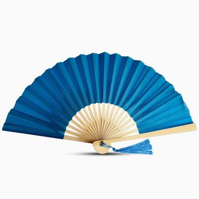 Blue hand fan with beige center and blue tassel on a white background