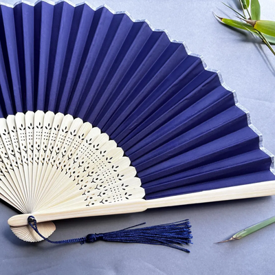 Blue and white hand fans on a light blue background