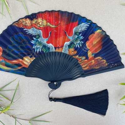 Decorative fan with colorful artwork on a light background
