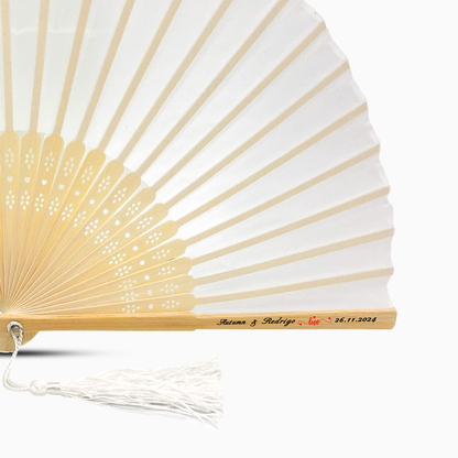 A White solid color hand fan, featuring a personal message printed  on main rib.