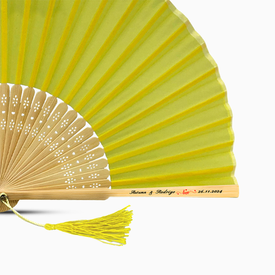 A Yellow solid color hand fan, featuring a personal message printed  on main rib.